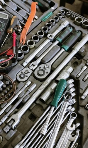 Detailed photo of various mechanic tools organized in a workshop setting. Perfect for repair themes.